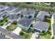 An aerial view of a neighborhood featuring well-maintained homes with dark roofs and landscaped yards at 3929 Corrine Dr, Orlando, FL 32814