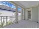 Charming balcony with white railing and pillars on a light blue home under a sunny sky at 3929 Corrine Dr, Orlando, FL 32814