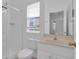 Bathroom with a shower, toilet, and vanity, illuminated by natural light from the window at 3929 Corrine Dr, Orlando, FL 32814