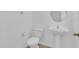 Clean, simple bathroom with a pedestal sink, toilet, and neutral-colored walls at 3929 Corrine Dr, Orlando, FL 32814