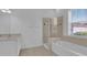 Bright bathroom featuring double vanity sinks, soaking tub, and a glass-enclosed shower at 3929 Corrine Dr, Orlando, FL 32814