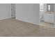 Bright bathroom with a toilet, vanity, and carpet flooring; white door and window at 3929 Corrine Dr, Orlando, FL 32814