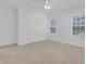 Bright bedroom with neutral carpet, double door closet, and two windows, offering a serene space at 3929 Corrine Dr, Orlando, FL 32814