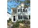 Two-story light blue house with black shutters, a front porch, and landscaping at 3929 Corrine Dr, Orlando, FL 32814