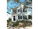 Two-story light blue house with black shutters, a front porch, and landscaping at 3929 Corrine Dr, Orlando, FL 32814