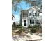 Two-story light blue house with black shutters, a front porch, and landscaping at 3929 Corrine Dr, Orlando, FL 32814
