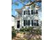 Two-story light blue house with black shutters, a front porch, and landscaping at 3929 Corrine Dr, Orlando, FL 32814