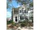Two-story light blue house with black shutters, a front porch, and landscaping at 3929 Corrine Dr, Orlando, FL 32814