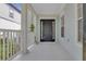 View of the home's front porch with classic columns and a dark front door at 3929 Corrine Dr, Orlando, FL 32814