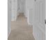 Hallway showcases neutral carpet and white doors, creating a cohesive and bright transition between rooms at 3929 Corrine Dr, Orlando, FL 32814
