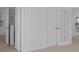 Bright hallway featuring white paneled doors and neutral-toned walls, creating a clean, modern aesthetic at 3929 Corrine Dr, Orlando, FL 32814