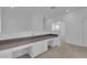 Bright hallway features built-in desk with white cabinets, ideal for a home office or study area at 3929 Corrine Dr, Orlando, FL 32814