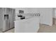 Kitchen with stainless steel fridge, island, white cabinets, and stainless steel appliances at 3929 Corrine Dr, Orlando, FL 32814