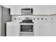 Stainless steel oven and microwave surrounded by white cabinets and backsplash at 3929 Corrine Dr, Orlando, FL 32814