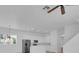 Bright, open kitchen with stainless steel appliances, white cabinets, and a ceiling fan at 3929 Corrine Dr, Orlando, FL 32814