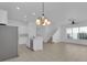 Open floor plan with kitchen island, modern lighting, stainless appliances, and stairs at 3929 Corrine Dr, Orlando, FL 32814