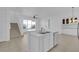 Open-concept living area with island sink, stairway, modern lighting, and natural light at 3929 Corrine Dr, Orlando, FL 32814