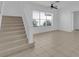 Neutral living area featuring a stairway, tile floors, fan, and lots of light at 3929 Corrine Dr, Orlando, FL 32814