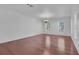 An expansive living room with hardwood floors and bright natural light from surrounding windows at 3929 Corrine Dr, Orlando, FL 32814
