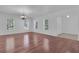 Sunlit living room features shiny hardwood floors, crown molding and two large windows at 3929 Corrine Dr, Orlando, FL 32814