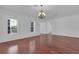 A formal living room boasts hardwood floors, a chandelier, and lots of natural light at 3929 Corrine Dr, Orlando, FL 32814