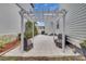 Outdoor pergola seating area with two comfortable chairs on a tiled patio at 3929 Corrine Dr, Orlando, FL 32814