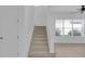 Bright stairway with neutral carpet and natural light from a nearby window at 3929 Corrine Dr, Orlando, FL 32814
