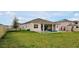 Grassy backyard with an in-ground pool and covered lanai, perfect for outdoor living at 4223 Sunset Preserve Blvd, Orlando, FL 32820