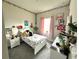 Charming bedroom with floral accents, complemented by whimsical decor and bright, natural light at 4223 Sunset Preserve Blvd, Orlando, FL 32820
