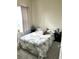 A cozy bedroom with a marble-patterned comforter, complemented by dark nightstands and soft lighting at 4223 Sunset Preserve Blvd, Orlando, FL 32820