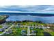 Scenic aerial view of a residential community nestled by a serene lake, offering a peaceful and picturesque living environment at 4223 Sunset Preserve Blvd, Orlando, FL 32820