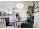 Bright and airy dining area with a glass table and a view of the modern kitchen with white cabinetry at 4223 Sunset Preserve Blvd, Orlando, FL 32820