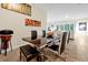 Chic dining room with a modern table, sleek chairs, and view into living room, creating a sophisticated ambiance at 4223 Sunset Preserve Blvd, Orlando, FL 32820