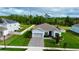 Charming single-story home with a well-manicured lawn, garden beds, and a brick paver driveway at 4223 Sunset Preserve Blvd, Orlando, FL 32820