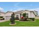 Attractive home featuring a well-maintained lawn, lovely landscaping, and a brick paver driveway at 4223 Sunset Preserve Blvd, Orlando, FL 32820