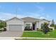 Beautiful single-story home with a two-car garage and an inviting landscaped front yard with garden beds at 4223 Sunset Preserve Blvd, Orlando, FL 32820