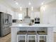 Modern kitchen with a spacious island, stainless steel appliances, and sleek white cabinetry for a clean aesthetic at 4223 Sunset Preserve Blvd, Orlando, FL 32820