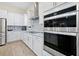Well-equipped kitchen showcasing stainless steel appliances, white cabinets, and stylish backsplash at 4223 Sunset Preserve Blvd, Orlando, FL 32820