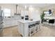 Modern kitchen featuring an island with seating, sleek white cabinets, and stainless steel appliances at 4223 Sunset Preserve Blvd, Orlando, FL 32820