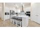 Stylish kitchen featuring a large island with seating, white cabinets, stainless steel appliances, and pendant lighting at 4223 Sunset Preserve Blvd, Orlando, FL 32820
