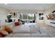 Bright living room with a white leather couch and view of the outdoor pool at 4223 Sunset Preserve Blvd, Orlando, FL 32820