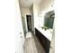 Bathroom featuring dual sinks, a large mirror, sleek cabinetry, a walk-in shower, and modern lighting fixtures at 4223 Sunset Preserve Blvd, Orlando, FL 32820