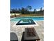Backyard pool with integrated spa and fire pit area, perfect for outdoor entertaining at 4223 Sunset Preserve Blvd, Orlando, FL 32820