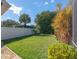 Landscaped backyard with a well-maintained lawn and a white fence at 5138 Andrea Blvd, Orlando, FL 32807