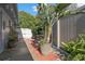 Backyard patio features a bench, potted plants, privacy fence, and lush greenery at 5138 Andrea Blvd, Orlando, FL 32807
