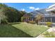Expansive backyard with lush lawn, mature trees and screened-in pool at 5138 Andrea Blvd, Orlando, FL 32807