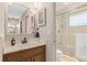 Well-lit bathroom featuring tile flooring, neutral paint, vanity, and glass shower at 5138 Andrea Blvd, Orlando, FL 32807