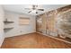 Bedroom with unique wall art, neutral walls, parquet floors, and two windows at 5138 Andrea Blvd, Orlando, FL 32807