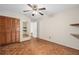 A bedroom with parquet floors, floating shelves, and wood closet doors at 5138 Andrea Blvd, Orlando, FL 32807