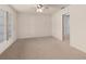 Bedroom featuring neutral walls, carpet flooring, a ceiling fan, and an entrance to another room at 5138 Andrea Blvd, Orlando, FL 32807